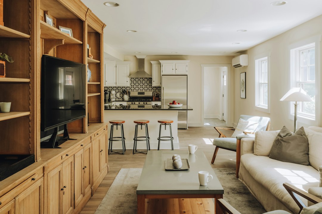 Spacious living room and kitchen with wooden built-in shelves